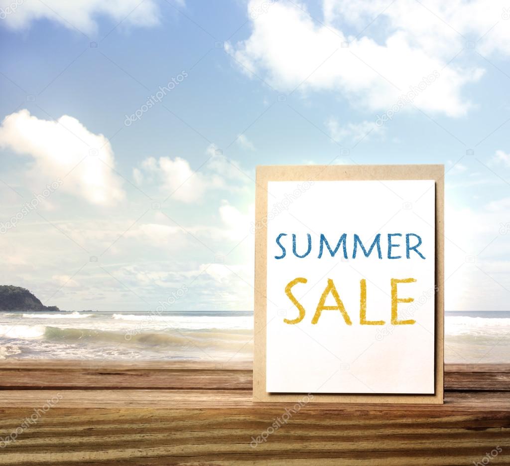 Summer sale sign over ocean and sky