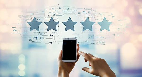 Rating star concept with person using smartphone — Stock Photo, Image