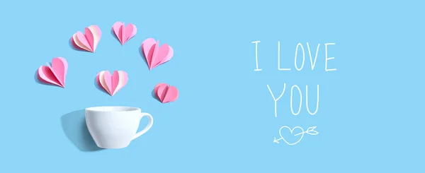 Miluji tě se vzkazem s šálkem kávy a papírovými srdci — Stock fotografie