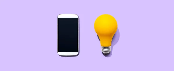 Smartphone con una bombilla amarilla —  Fotos de Stock