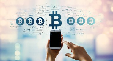 Akıllı telefon kullanan kişi ile Bitcoin temasıName