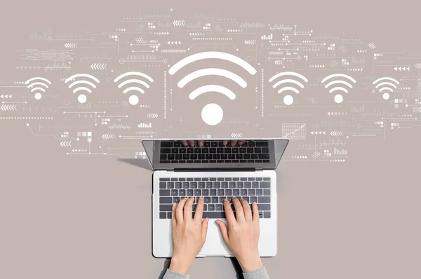 Tema Wifi con la persona usando el ordenador portátil —  Fotos de Stock
