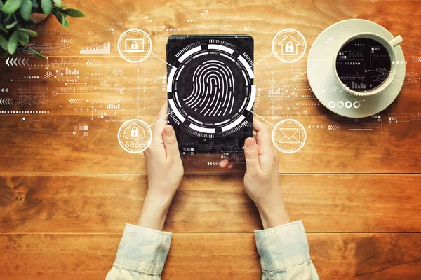 Fingerprint scanning theme with a person holding a tablet — Stock Photo, Image