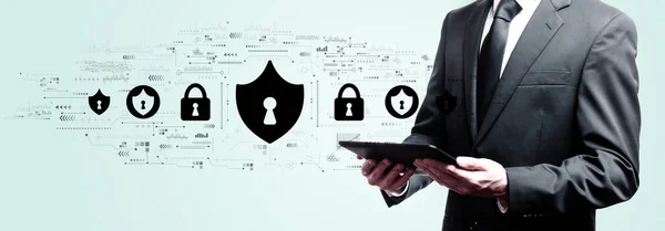 Cyber security tema med affärsman som håller en tablett — Stockfoto