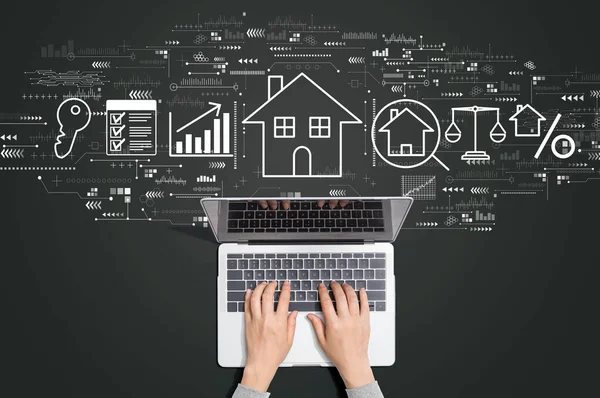 Real estate theme with person using laptop — Stock Photo, Image