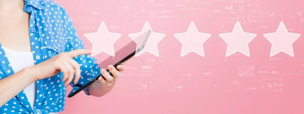 Rating star concept with woman using a tablet — Stock Photo, Image