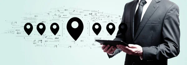 Map pin concept with businessman holding a tablet — Stockfoto