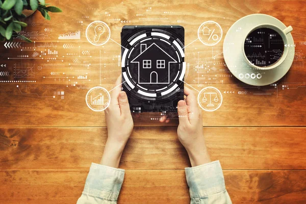 Real estate theme with a person holding a tablet — Stock Photo, Image
