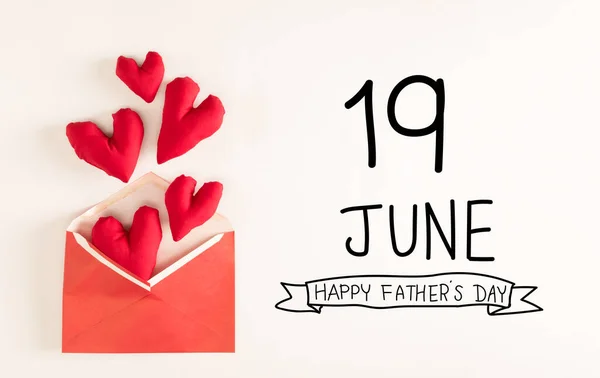 Fathers Day message with red heart cushions coming out of an envelope
