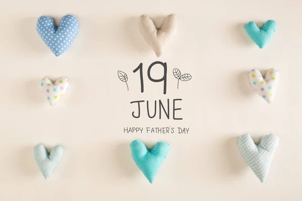 Fathers Day message with blue heart cushions on a white paper background