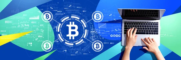 Bitcoin theme with person using a laptop computer