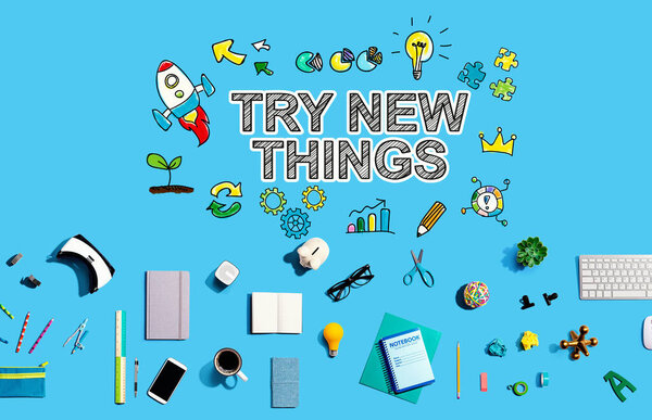 Try New Things with collection of electronic gadgets and office supplies