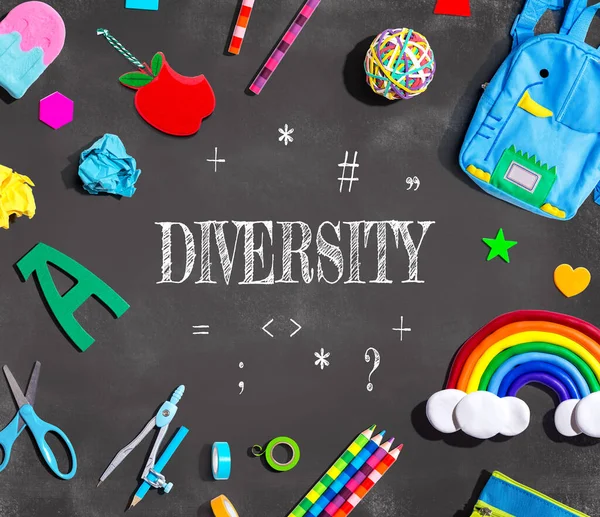 Diversity theme with school supplies on a chalkboard - flat lay
