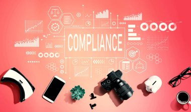 Compliance theme with electronic gadgets and office supplies - flat lay