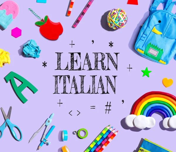 Learn Italian theme with school supplies on a purple background - flat lay