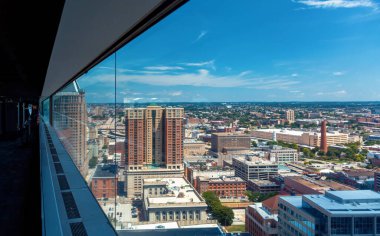 Looking out at the Baltimore cityscape from a large window