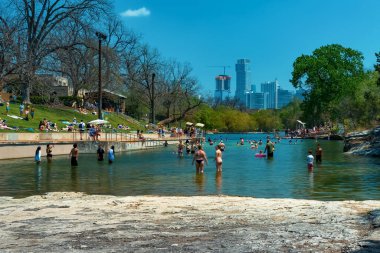 Barton Springs natural cold spring swimming pool in downtown in Austin Texas clipart