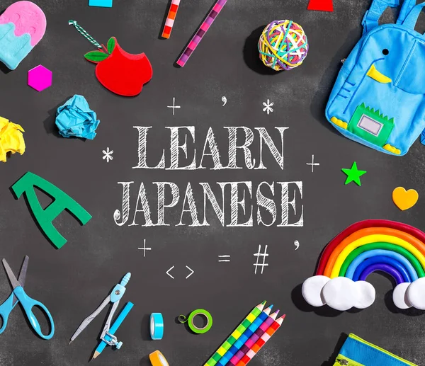 Learn Japanese theme with school supplies on a chalkboard - flat lay