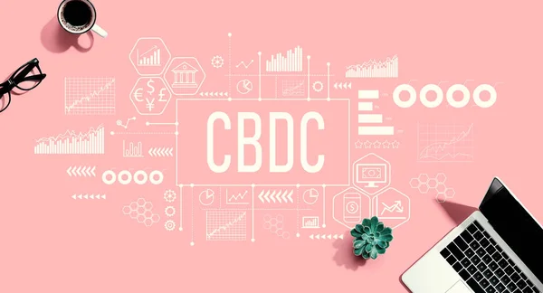 CBDC - Central Bank Digital Currency Concept with a laptop computer on a pink background