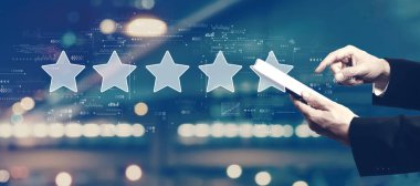 Rating star concept with businessman using a tablet computer
