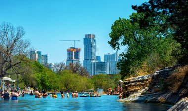 Barton Springs natural cold spring swimming pool in downtown in Austin Texas clipart
