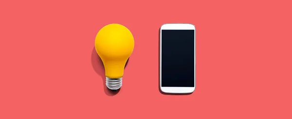 Smartphone Con Una Lampadina Gialla Dall Alto — Foto Stock