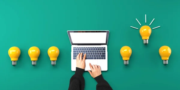 Idea light bulbs with person using a laptop computer from above