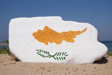 Cyprus flag painted on a stone with sand background clipart