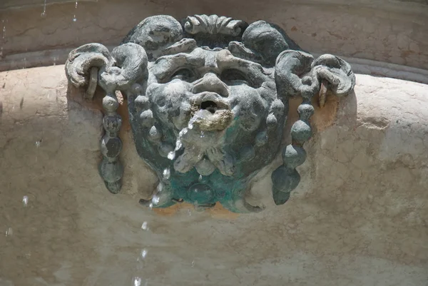 Fountain's ornamental bronze mask, Loreto, Italy — Stock Photo, Image
