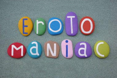 Erotomaniac, one affected with erotomania, creative text composed with multi colored stone letters over green sand