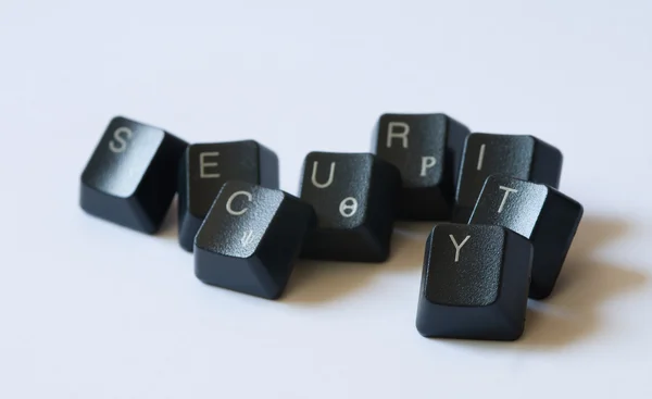 Слово безопасности с клавиатурой на белом фоне — стоковое фото