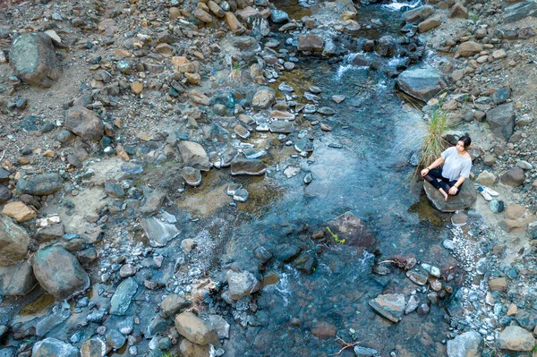 Genç bir kadın nehir kenarında meditasyon yapıyor. Yoga doğada egzersiz yapıyor. İHA hava fotoğrafı — Stok fotoğraf