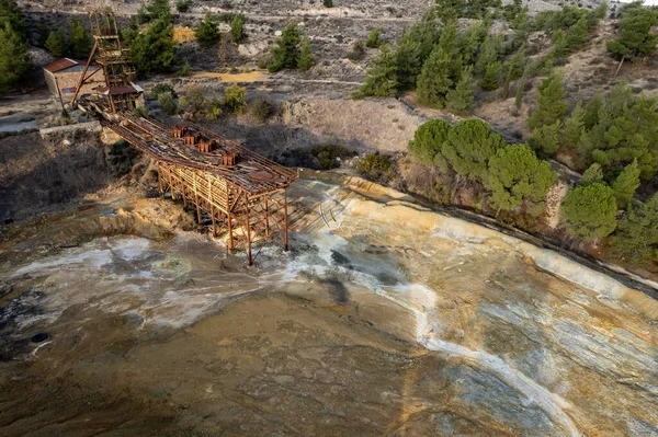 Aerial drone view of abandoned copper mine rusty structure with red toxic dry sand. Environmental pollution. — Stock Photo, Image