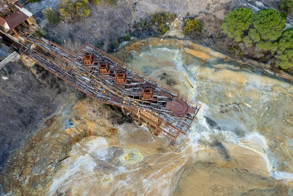 Aerial drone view of abandoned copper mine rusty structure with red toxic dry sand. Environmental pollution. — Stock Photo, Image