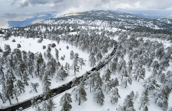 Drone aerial of highway road on the snowy forest mountain in winter. — Stock Photo, Image