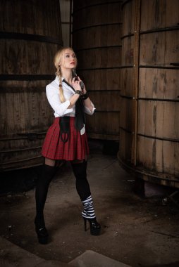 Woman in casual clothing with gun pistol pointing her neck.