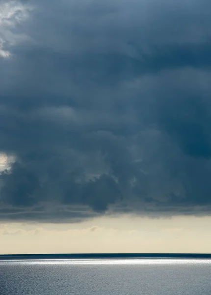 Stormachtige wolken met dramatische lucht boven de zee bij zonsondergang — Stockfoto