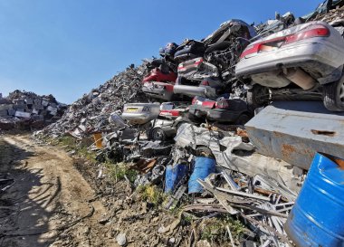 Pile of various scrap cars and other metals on a junk yard ready recycling industry.