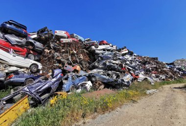 Pile of various scrap cars and other metals on a junk yard ready recycling industry.