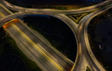 Aerial drone view of highway junction. Roundabout cars moving fast. Transportation infrastructure