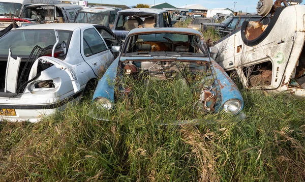 stock image Car junkyard outdoor with wreck of a destroyed cars. Environmental pollution metal recycling.