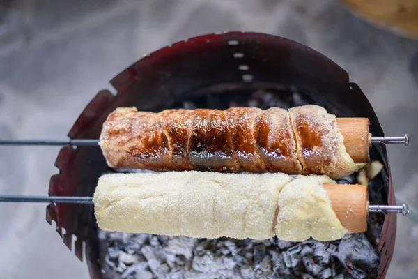 Chimney Cake baking on coal, coated in sugar.