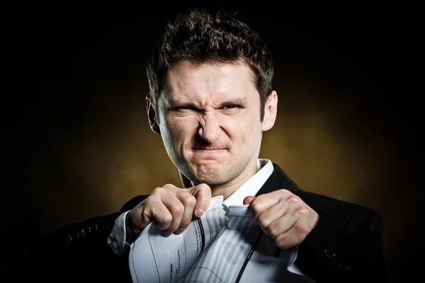 Man in a suit tearing furiously invoice — Stock Photo, Image