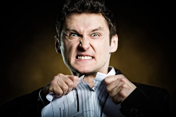 Angry businessman tearing invoice — Stock Photo, Image