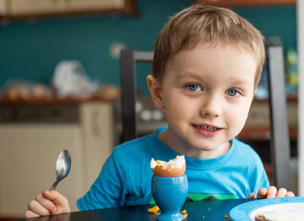 Little three year old boy eats an egg — Stock Photo, Image