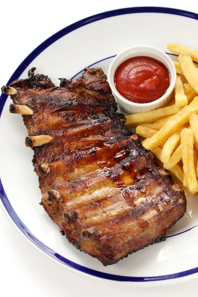 Barbecued pork spare ribs and french fries — Stock Photo, Image