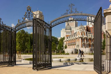 Madrid, Spain - May 10, 2022. The new Plaza de Espana square with the entry to the Sabatini Gardens in the foreground and the Madrid downtown skyline in the background. Madrid, Spain.
