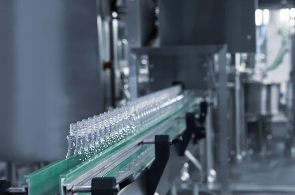 Process of water bottling plant. Plastic bottle on conveyor belt in beverage factory.