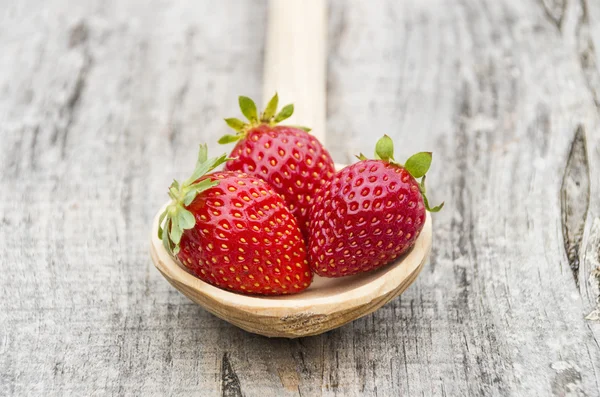 Strawberries in a wooden spoon — Stock Photo, Image