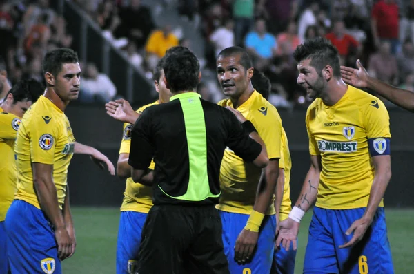 Soccer players protesting against referee